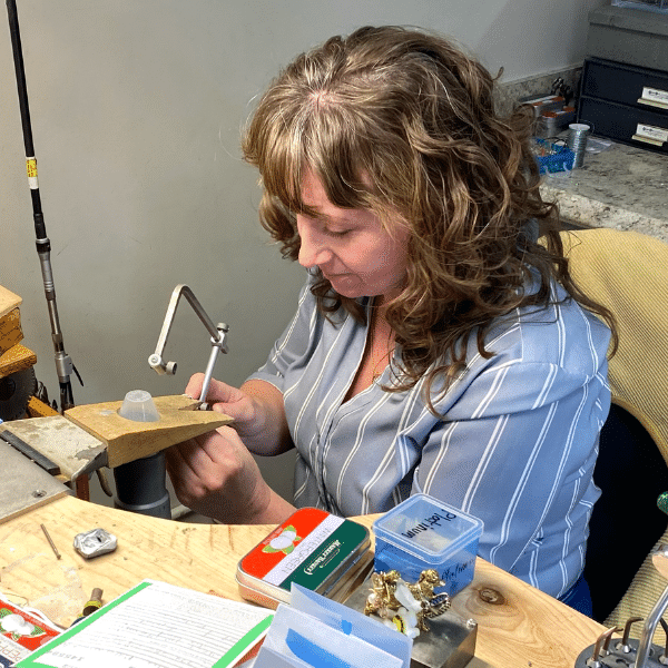 Kerry, a bench jeweler at Joy-Den Jewelers in Marlborough, MA, working on a piece of jewelry.